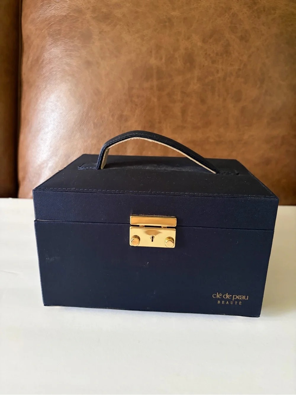 NWOT Cle’ de Peau elegant blue satin small/travel jewelry box. Mirror. Drawer